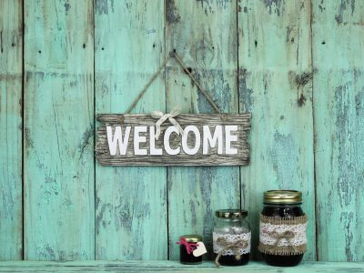 Welcome sign hanging over jars of jam