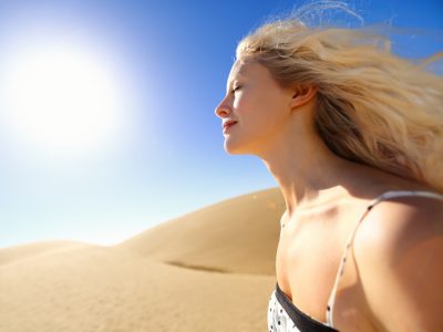 Sun skin care woman enjoying desert sunshine