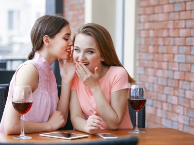 Young women drinking wine in cafe