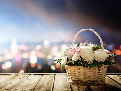 flowers in basket and lights of night city