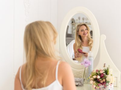 Beautiful Blonde Woman Looking In Mirror Brush Hair, Young Girl Morning Happy Smiling Back Rear View