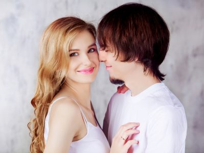 happy young couple against studio background