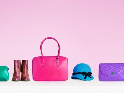 Colorful hand bags,purse,shoes, and hat isolated on pink background. Woman fashion accessories items. Shopping image.