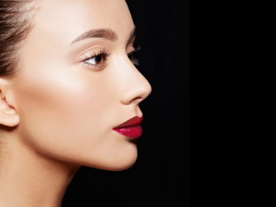 Beautiful woman profile isolated on black background. Cosmetic makeup image.